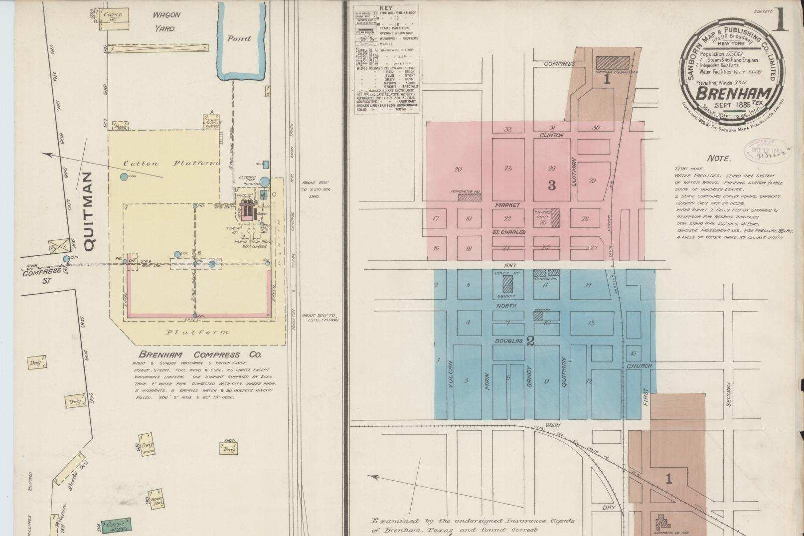 A hand colored fire insurance map sheet showing a cotton compress platform and oil works in yellow, a key map of the business blocks tinted pink and blue, a circular title seal reading Brenham, Sept. 1885, and a handwritten certification signed by two local insurance agents.